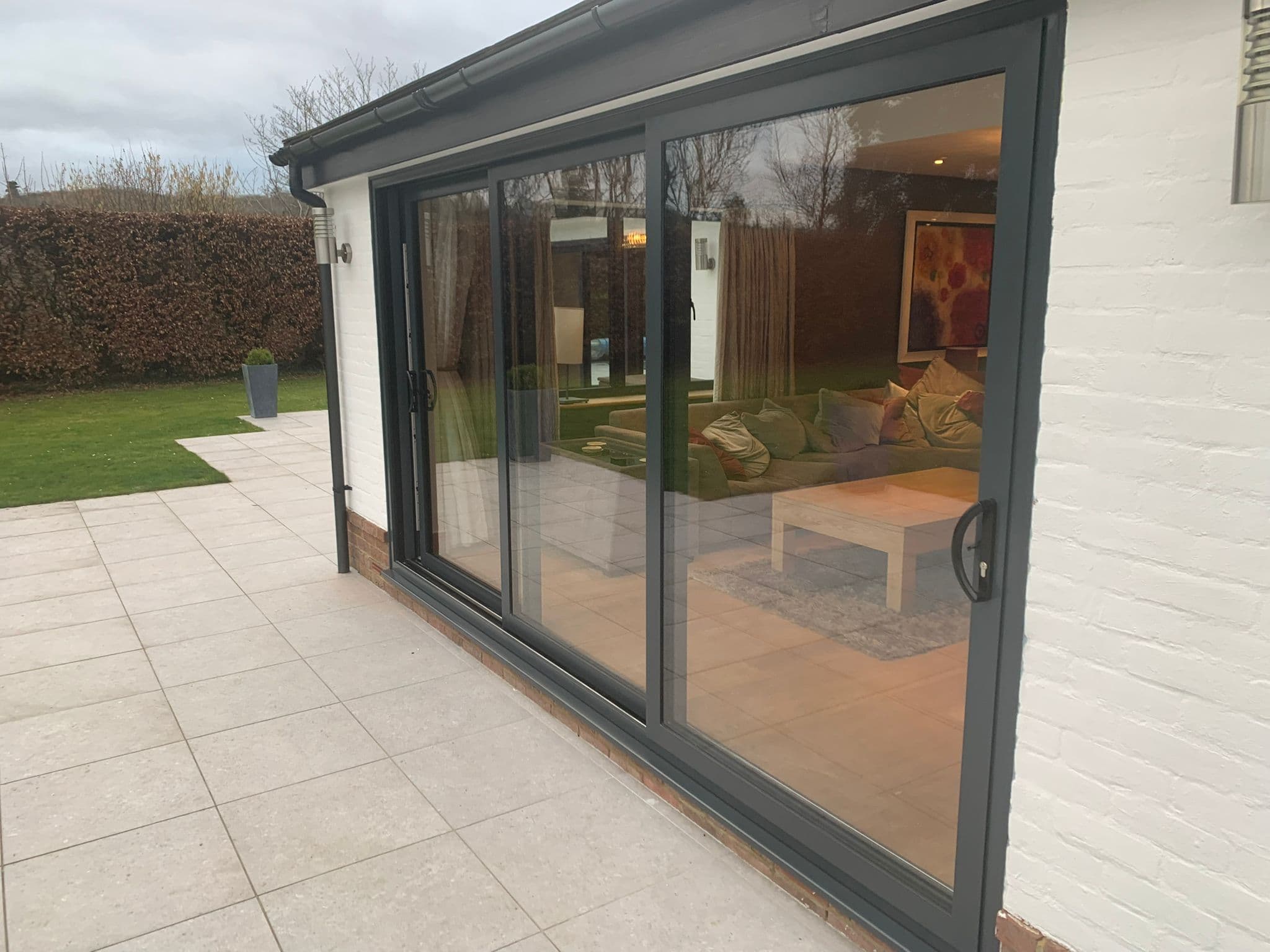 Smart Visoglide aluminium patio sliding doors onto a Surrey garden