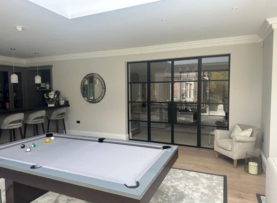 Smart Aluspace internal aluminium doors in black, dividing two rooms in a Surrey home