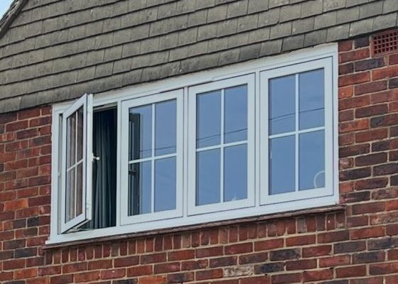 White flush casement windows with Georgian bars on a brick home