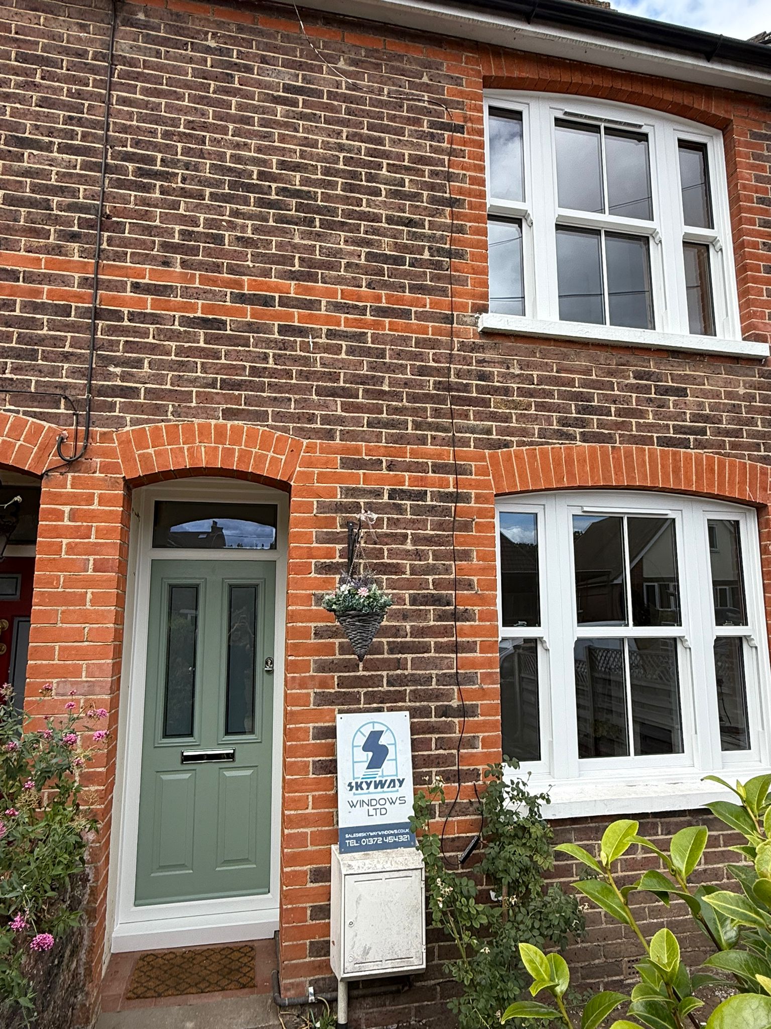 White uPVC sash windows on a Surrey brick terrace